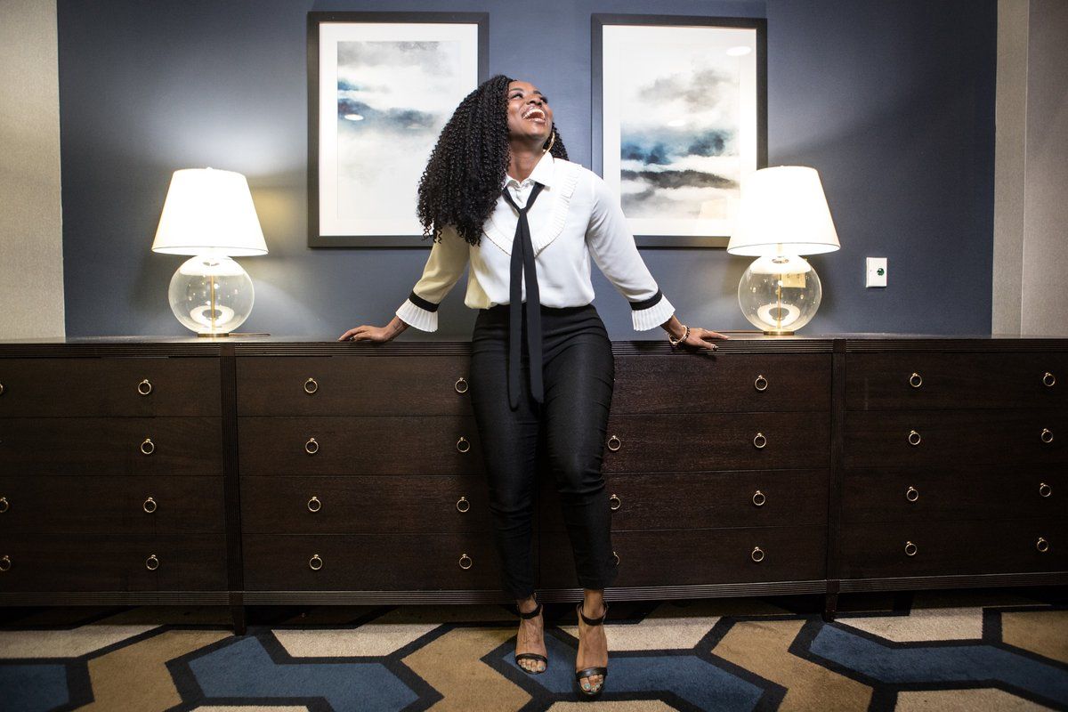 Personal branding portrait laughing in a hotel suite