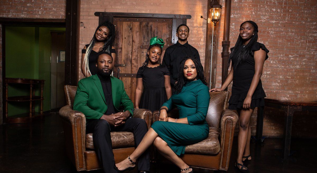 Family portrait in a brick loft with leather chairs